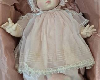 1388 - Madame Alexander Mommy's Pet Doll 18" (Description): Mommy's Pet doll measuring 18 inches. This  porcelain baby doll features a delicate pink  dress with lace trim and a matching  lace-trimmed bonnet. Accompanied by a small  plush teddy bear.