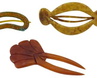 1728 - 3 Vintage Celluloid Hair Accessories (Description): A collection of three vintage celluloid hair  accessories. The group includes varied styles  and colors characteristic of early plastic  hair ornaments.