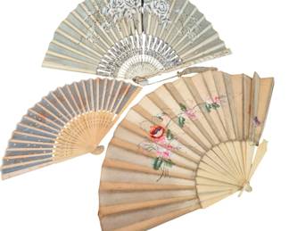 1441 - 3 Celluloid Handle Folding Fans (Description): The set includes a pale blue fan with white  floral embroidery and decorative pierced  guards, a blue fan with gold star accents and  pierced wooden sticks, and a cream-colored  fan featuring hand-painted roses and floral sprays. All display characteristic Victorian  styling suitable for display. Longest 12"  long