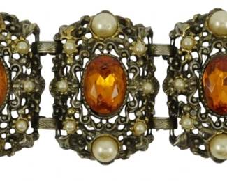 1896 - Austro-Hungarian Style Bracelet (Description): An Austro-Hungarian style bracelet featuring  ornate metalwork with decorative stones and  pearl accents throughout the linked design.