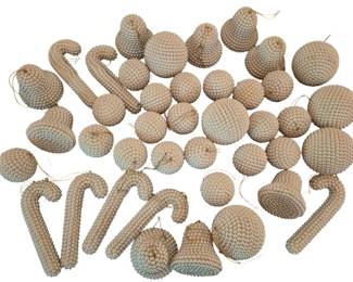 4075 - Large Group of Pearled Christmas Ornaments (Description): A large group of pearled Christmas ornaments  featuring various decorative shapes including  balls, bells, hearts, and candy canes. Each  ornament is covered in small faux pearl beads  in a cream or champagne color, creating an elegant vintage aesthetic. The collection  includes ornaments of varying sizes, all with  hanging loops for tree display.