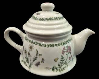 2818 - Andrea by Sadek Botanic Garden Style Teapot (Description): Ceramic teapot featuring a botanical garden  motif with floral designs including daisies  and pink flowers, delicate butterflies, and a  green leafy vine border. The teapot has a  distinctive beehive-shaped ribbed lid with a rounded finial. The piece features a curved  handle and graceful spout, with coordinating  vine decoration on the lid. Measures 5" x 7"  x 4".