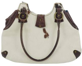 1842 - Vintage Tanner Cow Hide Handbag 11"x15"x2" (Description): Vintage Tanner cow hide handbag featuring  natural cowhide with brown and white  coloring. The bag is accented with brown  leather trim, handles, and corner details,  along with brass-tone hardware including decorative rings and studs. Measures 11  inches wide by 15 inches tall by 2 inches  deep.
