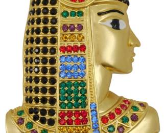 1930 - Mid Century Pharaoh Brooch (Description): Mid Century Pharaoh brooch featuring an  Egyptian-inspired design. The gold-toned  piece depicts a pharaoh in profile with an  elaborate headdress and collar adorned with  colorful rhinestones in red, blue, green, purple, amber, and black.