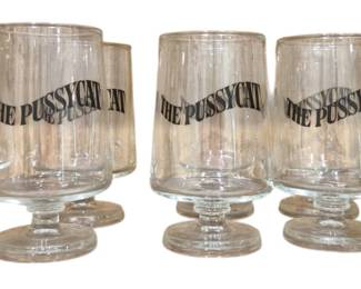 3964 - 10 Vtg The Pussycat Bar Footed Glasses (Description): Set of ten vintage bar glasses from The  Pussycat. Each footed glass features bold  black lettering reading "THE PUSSYCAT" in a  wavy design around the upper portion. The  glasses have a tulip-shaped bowl with a short stem and round foot, typical of mid-century  cocktail stemware.