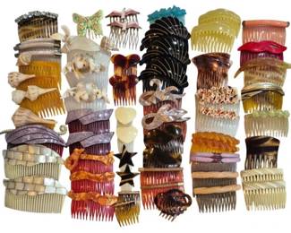 1987 - Group Vtg Decorative Hair Combs (Description): A large group of vintage hair combs in  assorted styles, materials, and colors. The  collection includes decorative side combs  featuring various embellishments such as  butterflies, bows, shells, stars, and floral motifs. Materials range from plastic and  celluloid to mother of pearl inlay and  rhinestone accents. Colors include amber,  tortoiseshell, black, clear, pink, red, and  neutral tones. An excellent assortment