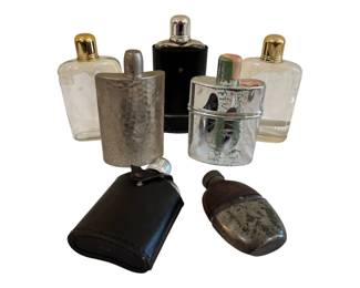 571 - Group of Vintage Flasks (Description): The collection includes two clear glass  flasks with gold-tone caps, a hammered metal  flask, a black leather-wrapped flask with  chrome cap, a leather-covered flask, a small  flask with leather covering and metal base, and a glass flask with silver-tone lid  featuring etched decorative design. Various  styles and materials suitable for display or  use. Largest 8"