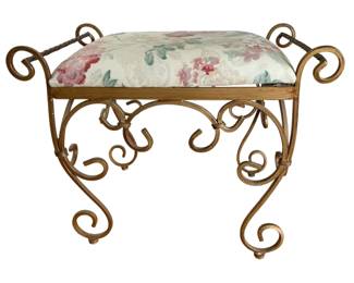 1415 - Heavy Iron Vanity Stool 19"x24"x14" (Description): Heavy iron vanity stool featuring an ornate  scrollwork base with a gilded finish. The  cushioned seat is upholstered in a floral  fabric.