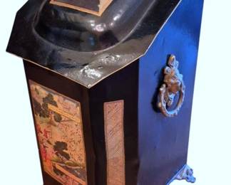 616 - Vtg Chinoiserie Decorated Black Coal Scuttle (Description): Vintage black lacquered coal scuttle  featuring chinoiserie decoration with  hand-painted scenic panels depicting figures  in garden landscapes. The slanted hinged lid  and front panel display polychrome Asian-inspired imagery with gold trim  accents. Fitted with ornate brass lion head  ring handles on the sides and resting on  decorative brass claw feet. Measures  24"x12"x12".