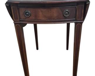 1260 - Vtg Mahogany Drop Leaf Side Table (Description): Vintage mahogany drop leaf side table  featuring elegant Federal style design with  satinwood inlay banding on the tapered legs  and drawer front. The table includes a single  drawer with brass ring pull hardware. The rich dark mahogany finish and refined  proportions make this piece suitable for use  as an accent table or small occasional table.  Measures 28" x 27" x 18" (opens to 35").