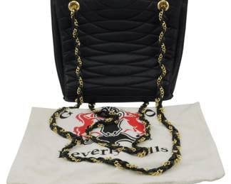 1817 - Vtg Leiorgio Quilted Leather Chain Tote (Description): Vintage Leiorgio quilted leather chain tote  with storage bag. The bag features a quilted  leather exterior with chain straps. Includes  original dust bag. Measures 8 inches by 10  inches by 3 inches.