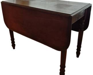 309 - Drop-Leaf Table Opens 48" 29"x39"x21" (Description): Antique drop-leaf table with turned legs,  opening to 48 inches wide. The table features  a rich dark wood finish with elegant turned  leg details and a single drawer. Measures 29  inches tall by 39 inches long by 21 inches deep with leaves down.