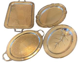 588 - 4 Silver Plate Platters w/ Meat Platter (Description): Collection of four silver plated platters  including a meat platter with tree-and-well  design for carving. The set features various  styles including oval and rectangular forms  with decorative borders. Largest platter measures 18 inches by 13.5 inches.
