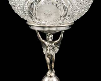 131 - New Amsterdam Quadruple Plate Cut Glass Bowl (Description): New Amsterdam quadruple plate cut glass bowl  with figural stand. The brilliant cut glass  bowl features intricate diamond and starburst  patterns, supported by a classical male  figure holding the bowl aloft, standing atop a domed base. Measures 11 inch