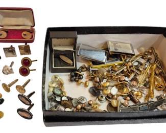 2706 - Group Men's Cufflinks, Tie Clips & More (Description): A large assortment of men's accessories  including cufflinks, tie clips, tie bars, and  collar studs. The collection features  various styles and materials including  gold-tone, silver-tone, and copper finishes. Several pairs of cufflinks are presented in  their original presentation boxes. The  assortment includes decorative examples with  gemstone accents, enamel work, and engraved  designs spanning various periods.
