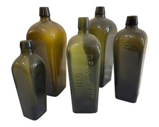 558 - Green Glass Gin Bottles 11" (Description): Group of five antique green glass bottles,  including a De Kuyper Gin case bottle with  embossed lettering. The collection features  various shades of olive and amber-green glass  in both cylindrical and rectangular case-style forms. Each bottle retains its  original applied lip. Tallest measures 11  inches.