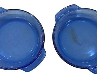 920 - 2 Anchor Hocking Cobalt Blue Glass Pie Plates (Description): Includes plates with tab handles in two  sizes, measuring 10 inches and 8 inches by 2  inches. The translucent blue coloring is  characteristic of Anchor Hocking's popular  cobalt glass line.