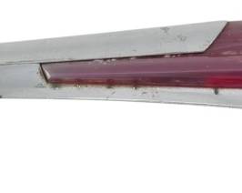 1887 - Vintage Chevrolet Deluxe Hood Ornament (Description): Vintage Chevrolet Deluxe hood ornament  featuring chrome body with red accent panel.  Measures 2 inches by 14 inches by 2 inches.