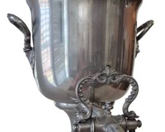 628 - Antique Silver Plate Samovar 13" (Description): Featuring an elegant urn form with decorative  side handles, ornate spigot with scrollwork  surround, domed lid with decorative finial,  and a stepped pedestal base. Measures 13  inches tall.