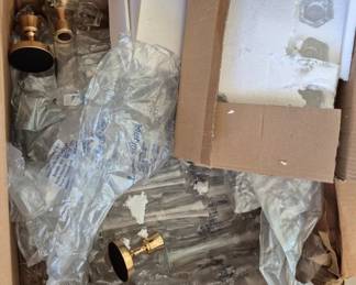 2834 - Box of Assorted Candles, Vases & More (Description): A box containing assorted candles, vases, and  related decorative items. The lot includes  glass candlesticks with hexagonal bases in  original packaging, brass-tone candle  holders, and various glass vases still in protective wrapping.