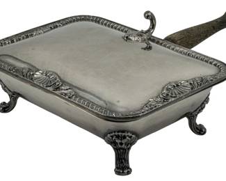 712 - King George Silver Plate Butler/Crumb Catcher (Description): King George silver plate butler or crumb  catcher. This footed serving piece features  an ornate design with a wooden handle.  Measures 2 1/2 inches in height by 11 inches  in length by 8 inches in width.
