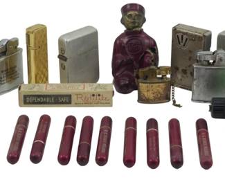 890 - Assorted Vtg Lighters & Smoking Accessories (Description): A collection of assorted vintage lighters and  smoking accessories. The group includes  various pocket lighters in gold-tone and  silver-tone finishes, a novelty figural  bellhop lighter, a Salem cigarette lighter, and several modern disposable lighters. Also  included are multiple burgundy bakelite  cigarette holders, a Ronson lighter  instruction booklet, and original packaging  for a Redilite lighter. A diverse assortment