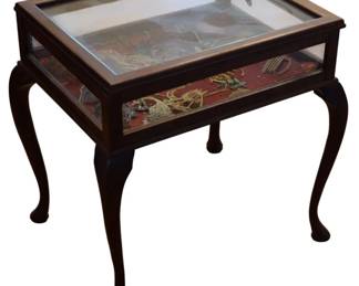 1732 - Showcase Table w/ Vtg Hair Accessories (Description): Showcase table with assorted contents of  vintage hair accessories. The glass-paneled  display case sits atop elegant cabriole legs  with pad feet. Measures 23.23 inches by 8  inches.