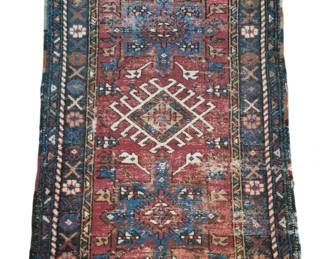 2798 - Antique Persian Tribal Wool Rug 53"x32" (Description): Antique Persian tribal wool rug featuring a  traditional geometric medallion design on a  red field. The rug displays intricate  diamond-shaped central motifs in white and  cream, surrounded by stylized botanical and geometric elements in shades of blue, gold,  and brown. A wide border with repeating  floral rosettes and X-pattern designs frames  the piece. The rug shows age-appropriate wear  consistent with its antique status, with