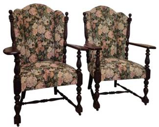 3717 - Pair Jacobean Style Upholstered Armchairs (Description): Pair of Jacobean style armchairs featuring  dark wood frames with turned legs and  stretchers, carved finials, and paddle-shaped  armrests. The chairs are upholstered in a  floral tapestry fabric with pink and cream roses against a dark background. Eachchair  measures 41 inches high by 34 inches wide by  25 inches deep.
