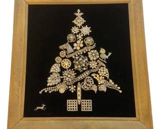 1167 - Framed Tree Art Collage of Costume Jewelry (Description): Vintage decorative brass art piece mounted on  black velvet. The artwork features an  arrangement of ornate costume jewelry forming  a decorative tree shape, presented in a  gold-toned frame. Measures 16 inches by 17.5 inches.