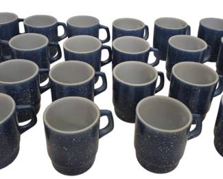 2753 - 22 Fire King Blue Speckled Coffee Mugs (Description): Collection of 22 Fire King mugs in a deep  blue speckled finish with gray interiors.  These classic American-made mugs feature the  characteristic sturdy construction and  D-shaped handles that Fire King is known for. The speckled glaze gives them a timeless,  rustic appeal suitable for everyday use.