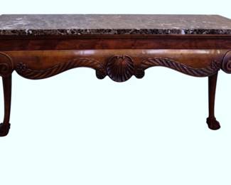 615 - Italian Marble Top Console Table 33"x60"x19" (Description): Italian marble top console table featuring a  richly grained brown and cream marble top  over a carved base. The apron displays  elegant shell and acanthus leaf carvings with  rope twist detailing. The table rests on graceful cabriole legs terminating in ball  and claw feet. Measures 33 inches high by 60  inches wide by 19 inches deep.