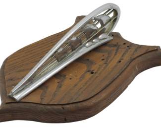 1880 - Vintage Plymouth Mayflower Hood Ornament (Description): Vintage Plymouth Mayflower hood ornament.  This classic automotive collectible features  the iconic Mayflower ship design that adorned  Plymouth vehicles. Mounted on a wooden  display plaque. Measures 4 inches by 10 inches by 7 inches.