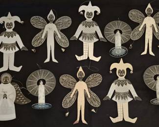 4070 - Group of 10 Stephanie Siegel Ornaments (Description): Group of ten Stephanie Siegel acrylic  ornaments featuring whimsical figural  designs. The collection includes fairies,  jesters, angels, and other fantastical  characters rendered in frosted and clear acrylic with etched decorative details.  Several feature wings, pointed caps, and  small bell embellishments. The ornaments  display a cohesive artistic style with  radiating sunburst patterns and delicate line