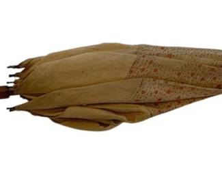1325 - Antique Peasant Cloth Parasol 27" (Description): Antique peasant cloth parasol with wooden  handle. The parasol features a tan fabric  canopy with subtle decorative pattern.