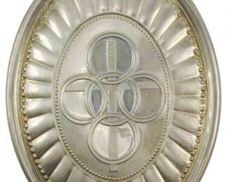 1955 - 1975 Towle Sterling Pendant 0.86oz (Description): A 1975 Towle sterling silver pendant  featuring a decorative design with  interlocking circular motifs and radiating  fluted edges. The oval pendant includes a  hanging loop at the top. Weighs 0.86 ounces.