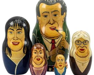 761 - Bill Clinton Lewinsky Scandal Nesting Dolls (Description): Set of five Russian nesting dolls depicting  figures from the Bill Clinton and Monica  Lewinsky scandal. The largest doll measures  6.5 inches tall.