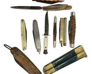 1200 - Vintage Collection of Assorted Pocket Knives (Description): A collection of vintage pocket knives  featuring various styles and handle  materials. The assortment includes examples  with mother of pearl, bone, jigged bone,  striped celluloid, brass, and green leather handles. Styles range from traditional  folding pen knives to multi-blade designs and  a small fixed blade knife. The knives show  age-appropriate patina and wear consistent  with antique and vintage pocket knives.