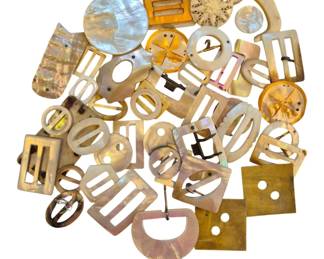 1458 - Asst Vtg Mother of Pearl Buckles & Buttons (Description): A collection of assorted vintage mother of  pearl buckles and buttons in various shapes  and sizes. The grouping includes rectangular  belt buckles with prong backs, circular dress  buckles, and decorative buttons. Several pieces feature the characteristic iridescent  sheen of natural mother of pearl, while  others display warm amber and golden tones.  Shapes range from geometric rectangles and  ovals to ornate carved designs. An excellent