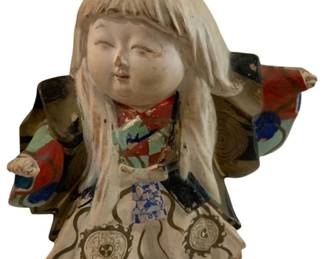 286 - Hakata Doll Clay Figure 6" (Description): Hakata doll crafted from clay, depicting a  traditional Japanese figure with long flowing  white hair and elaborately painted robes.  The figure wears a colorful layered kimono  decorated with red, blue, green, and gold accents, featuring decorative medallion  patterns on the white outer garment. The doll  displays characteristic Hakata styling with  a serene facial expression and outstretched  arms. Shows age-appropriate wear to the