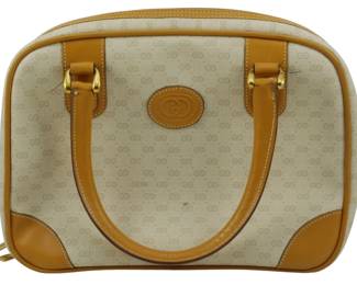 1790 - Vintage Gucci GG Monogram Dome Bag (Description): Vintage Gucci GG monogram dome bag featuring  the signature interlocking GG pattern on  coated canvas with tan leather trim and  handles. The bag includes a center leather  logo patch and gold-tone hardware. Measures 8.5 inches by 10.5 inches by 3.5 inches.