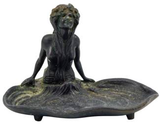 155 - Herbert D. Shivers Inc. Metal Ashtray (Description): A metal ashtray by Herbert D. Shivers Inc.,  featuring a figural design of a seated female  form integrated with a decorative tray base.  The piece measures 3 1/2" x 5" x 3".