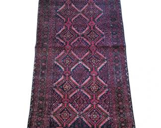 2800 - Vtg Persian Tribal Runner Rug (Description): The rug displays a rich color palette of deep  burgundy, rose, and navy blue tones with  geometric diamond patterns throughout the  central field.  Hand-knotted construction  with natural fringe ends. Measures 74 inches by 31 inches.