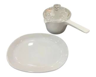 953 - Corning Ware White Platter & Saucepan w/ Lid (Description): Corning Ware white ceramic serving plate and  handled saucepan with clear glass lid. The  oval plate measures 9 inches by 10 inches.  Both pieces are in the classic white Corning  Ware style, suitable for cooking and serving.