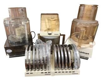 1252 - Cuisinart Food Processor Set w/ Accessories (Description): Cuisinart food processor set featuring three  food processor units in various sizes and  colors including black chrome and cream/white  models. The set includes an extensive  collection of stainless steel slicing and shredding disc blades organized in storage  racks. Accessories include work bowls, lids,  and instruction manual. A comprehensive  kitchen food preparation collection. Used as is electric/electronic/mechanical
