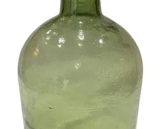957 - Vintage Green Glass Bottle 10"x6" (Description): This hand-blown style bottle features a  distinctive bulbous body with a long tapered  neck and applied lip. The glass displays a  lovely pale green coloration with amber tones  at the neck. Measures 10 inches tall by 6 inches in diameter.
