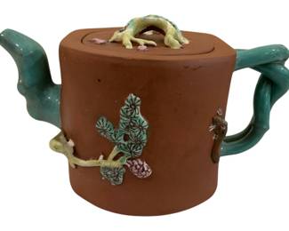 289 - Yixing Zisha Pottery Teapot 3.75"x7" (Description): Yixing Zisha pottery teapot featuring  traditional Chinese red-brown clay body with  applied enamel decoration. The teapot is  adorned with polychrome glazed pine branch  and floral motifs on the body. The spout and handle are sculpted as turquoise-glazed  bamboo branches, while the lid features a  yellow-green glazed branch-form finial with  pink floral accents. Measures 3.75 inches  high by 7 inches wide.