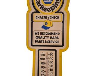 3937 - NAPA Good Carkeeping Advertising Thermometer (Description): Vintage NAPA automotive advertising  thermometer featuring the "Good Carkeeping"  slogan and classic NAPA logo. The shaped  metal sign displays "Chassis Check" with the  iconic NAPA cap graphic, along with "We Recommend Quality NAPA Parts & Service" text.  The thermometer shows both Fahrenheit and  Celsius scales, ranging from -40 to 120°F.  Finished in NAPA's signature yellow, blue,  and cream color scheme with a distinctive