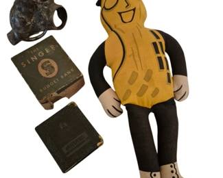 4182 - Vtg Mr. Peanut Doll w/ Singer Bank & More (Description): A vintage collection featuring a cloth Mr.  Peanut advertising doll with his  characteristic top hat, monocle, and cane  design. The lot also includes a cast metal  figural mouse holder, and a Singer Budget Bank in its original box.