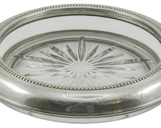 73 - Vintage BI Sterling & Glass Bottle Coaster (Description): Vintage OI sterling silver and glass bottle  coaster featuring a cut glass insert with a  starburst pattern. The sterling rim is  decorated with a beaded edge detail. Measures  1.5 inches tall by 6.5 inches in diameter.